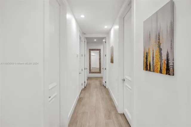 a view of a hallway with wooden floor