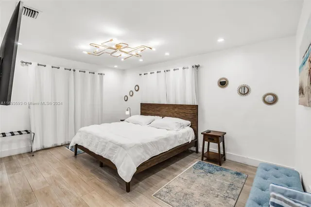 a spacious bedroom with a bed and a table