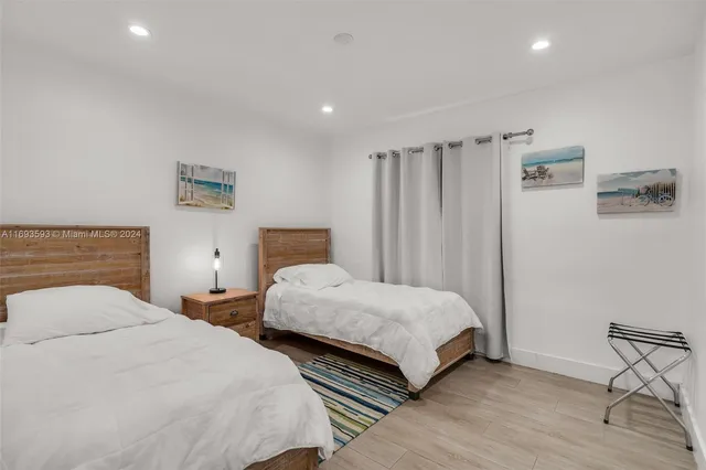 a bedroom with two beds and a table