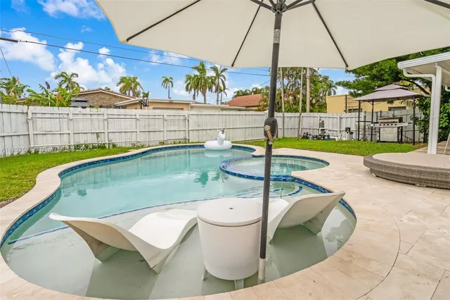 a view of a swimming pool with an outdoor seating