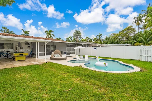 a view of a house with swimming pool and sitting area