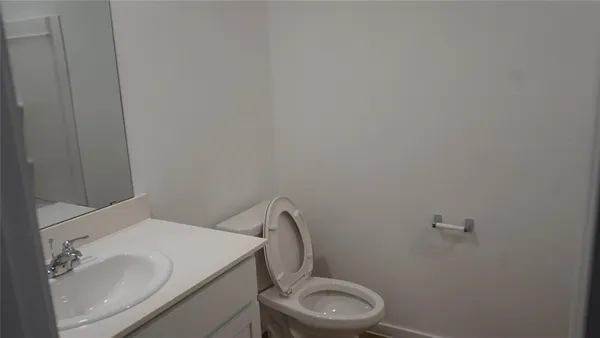 a white toilet sitting next to a white sink