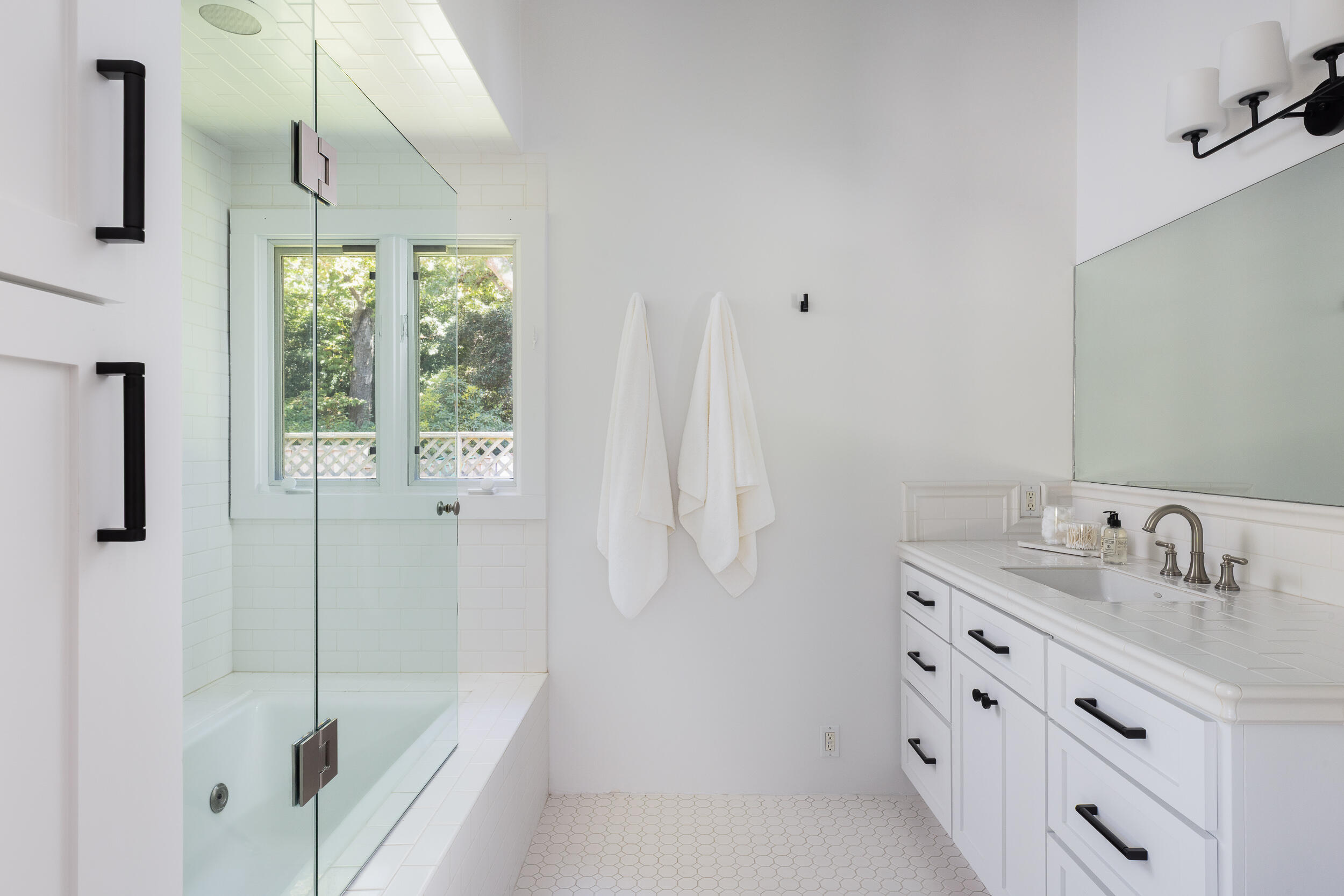 1515 East Valley Road, Unit C Santa Barbara, CA 93108 - Photo 16 of 22 a bathroom with a granite countertop sink a mirror and a bathtub
