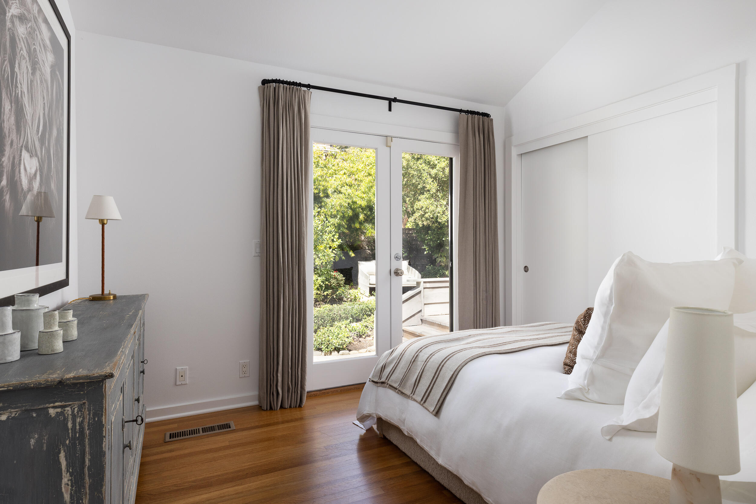 1515 East Valley Road, Unit C Santa Barbara, CA 93108 - Photo 17 of 22 a bedroom with a bed and wooden floor