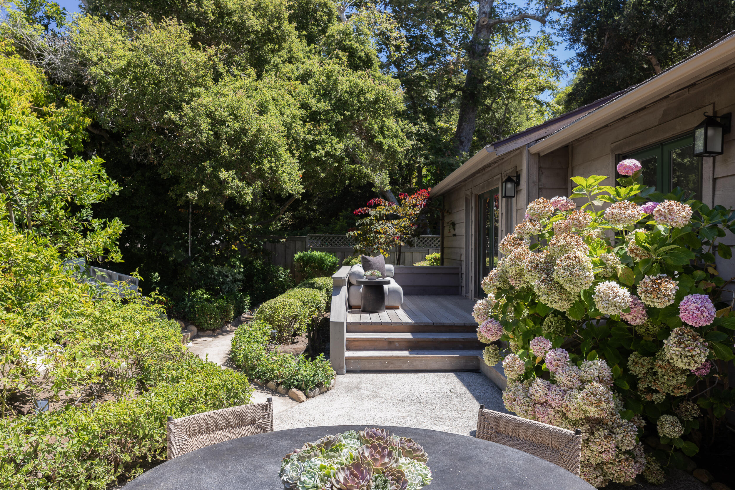 1515 East Valley Road, Unit C Santa Barbara, CA 93108 - Photo 19 of 22 a front view of a house with lots of plants and flowers