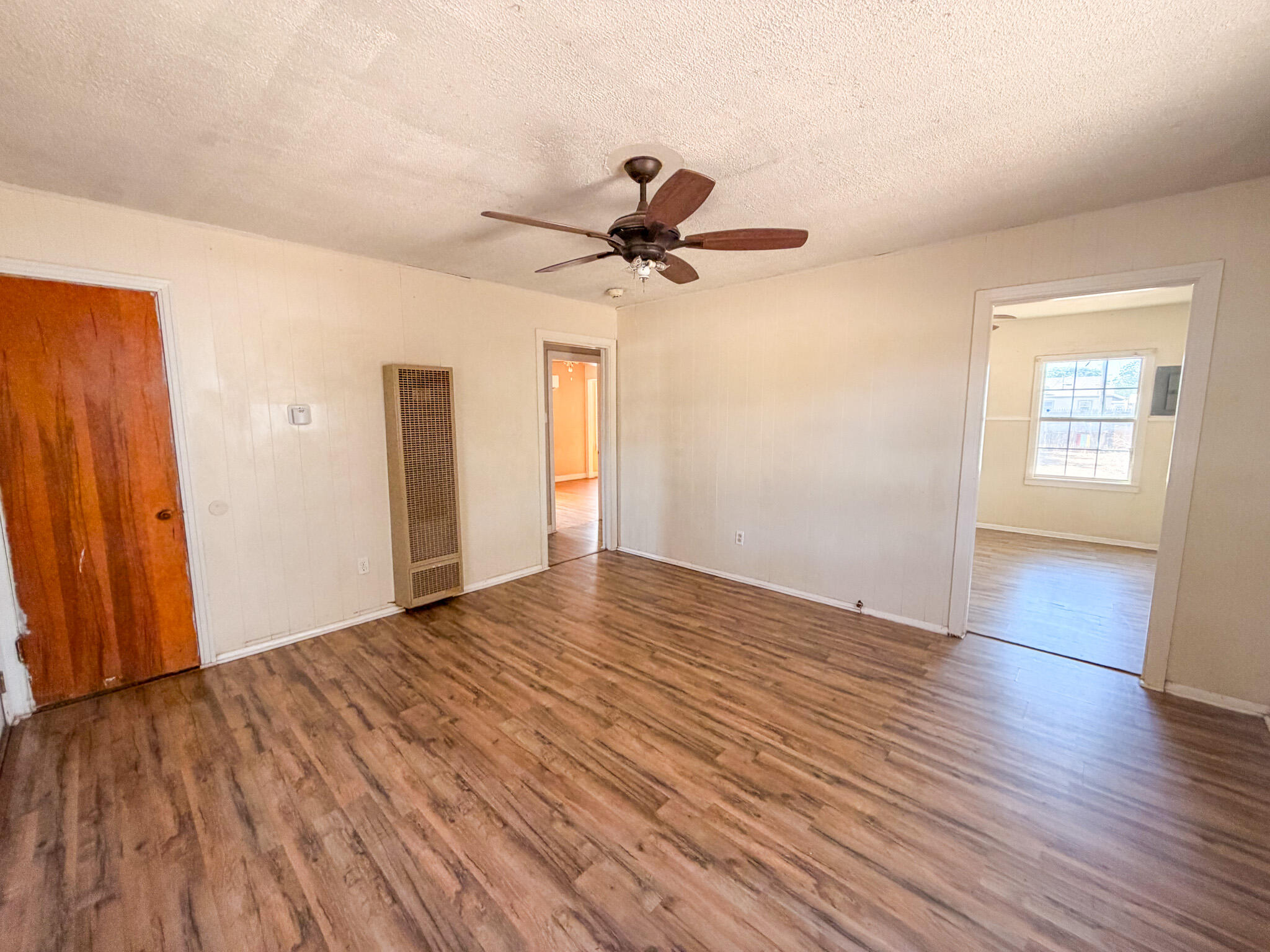 3207 Amherst Street Lubbock, TX 79415 - Photo 2 of 16 a view of empty room with wooden floor and fan