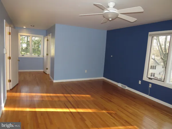 a view of room with window and ceiling fan