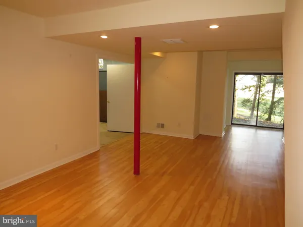 a view of a room with wooden floor and window
