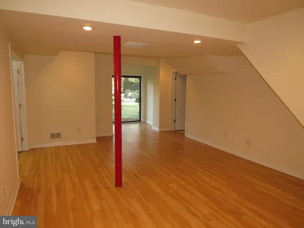 a view of a room with wooden floor and window