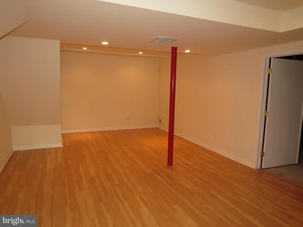 a view of a room with wooden floor and a sink