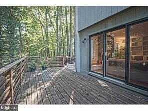 a view of backyard with wooden floor and floor to ceiling window