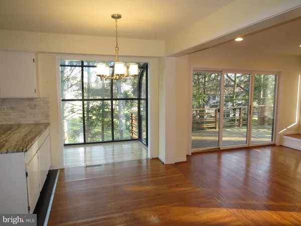 a view of an entryway with wooden floor