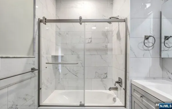 a bathroom with a shower and a tub