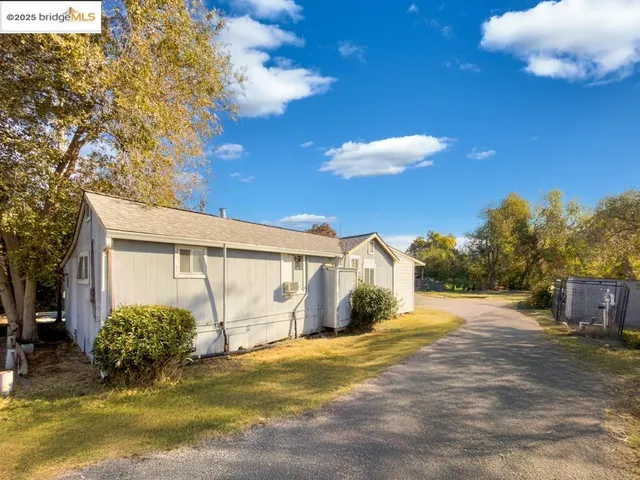 a view of a house with a yard and garage