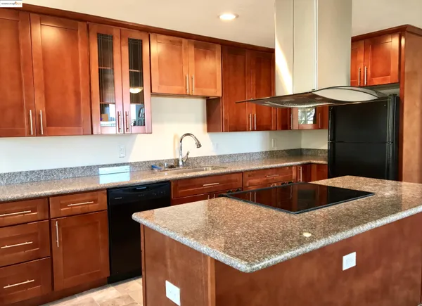 a kitchen with a sink cabinets and a window
