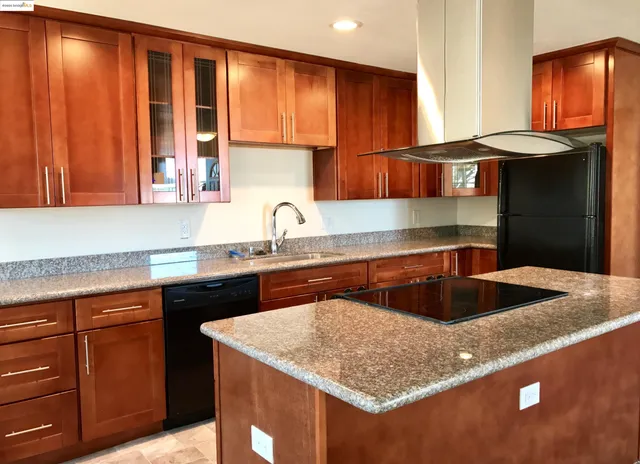 a kitchen with a sink cabinets and a window