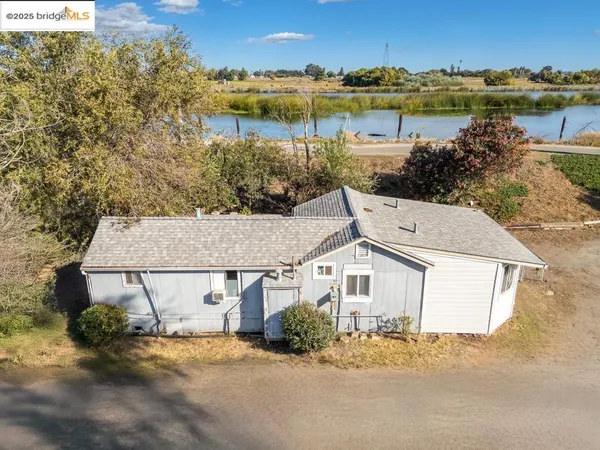 an aerial view of a house with a lake view