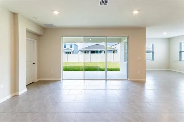 a kitchen with stainless steel appliances kitchen island granite countertop a refrigerator and a stove top oven