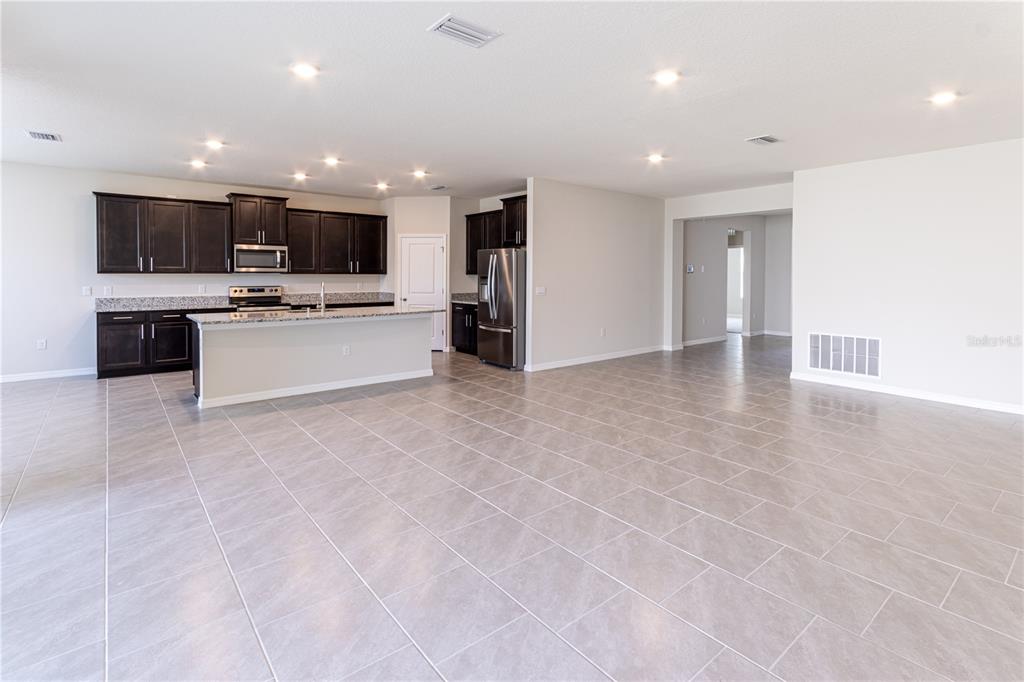 32183 Conchshell Sail Street Wesley Chapel, FL 33545 - Photo 21 of 45 a view of kitchen with stainless steel appliances kitchen island and living room with a large window