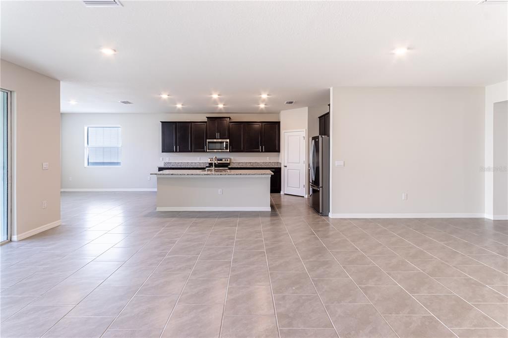 32183 Conchshell Sail Street Wesley Chapel, FL 33545 - Photo 22 of 45 a view of kitchen living space with stainless steel appliances wooden floor and chandelier