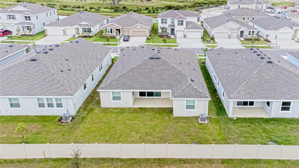 32183 Conchshell Sail Street Wesley Chapel, FL 33545 - Photo 43 of 45 an aerial view of residential houses with outdoor space and parking