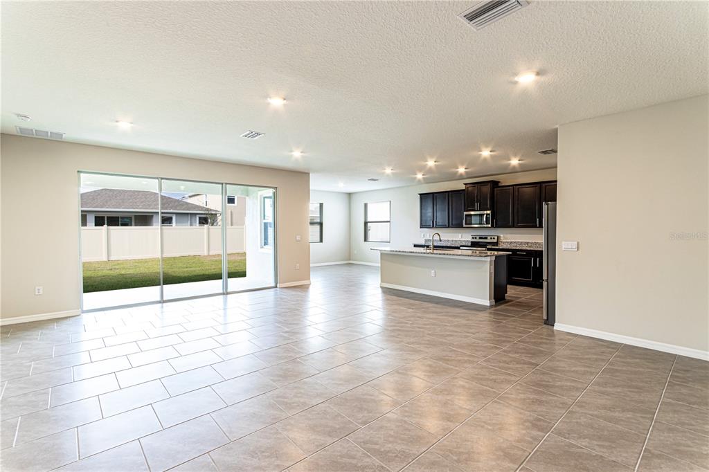 32183 Conchshell Sail Street Wesley Chapel, FL 33545 - Photo 45 of 45 a view of an empty room with kitchen view and appliances