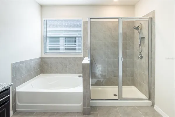 a white bath tub sitting next to a shower
