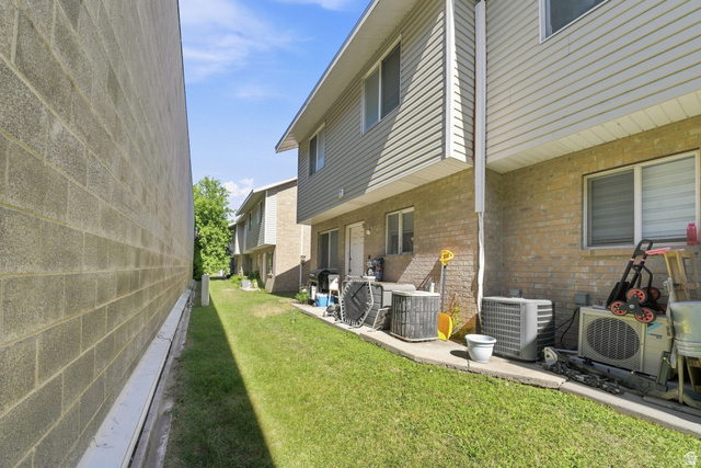 203 North Geneva Road, Unit 10 Provo, UT 84601 - Photo 21 of 30 Exterior featuring brick and vinyl siding, multiple windows, and a grassy perimeter
