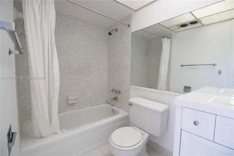 a bathroom with a sink toilet vanity and shower