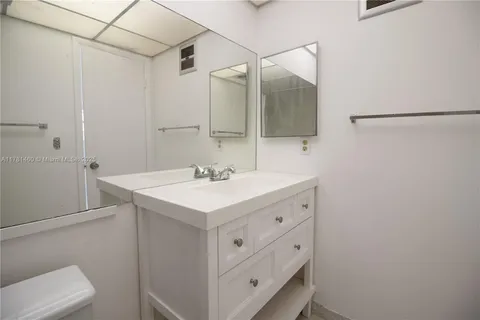 a bathroom with a sink vanity and a mirror