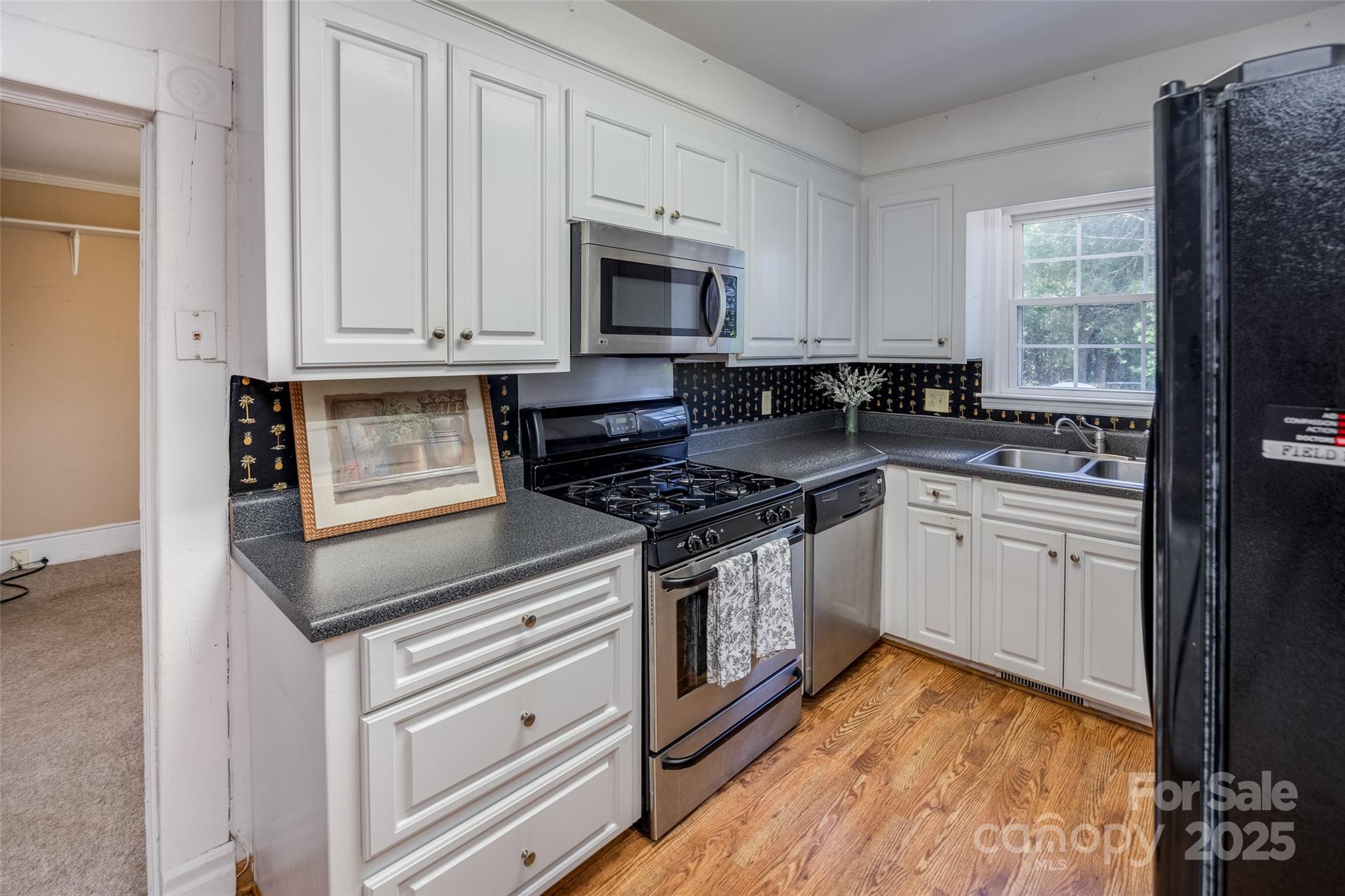 274 Old Harden Road Winnsboro, SC 29180 - Photo 10 of 39 a kitchen with granite countertop a stove sink and cabinets