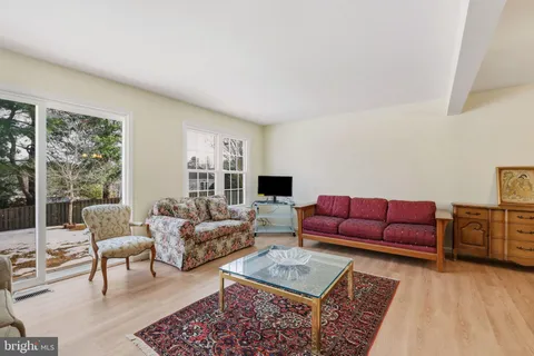 a living room with furniture couches and a flat screen tv