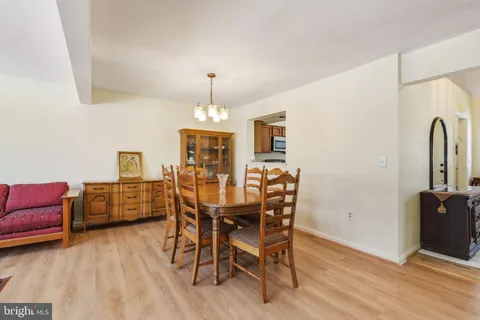 a dining room with furniture and wooden floor
