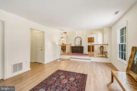 a living room with a couch and a wooden floor