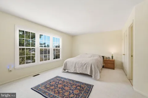 a spacious bedroom with a bed and a window