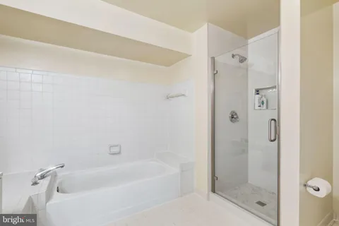 a bathroom with a bathtub shower and toilet