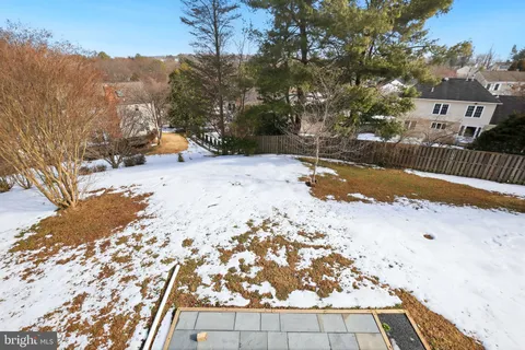 a view of a yard with wooden fence