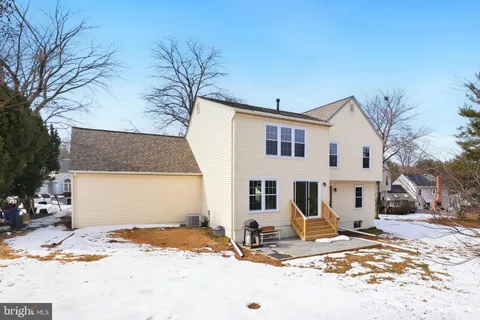 a view of a house with snow on the road