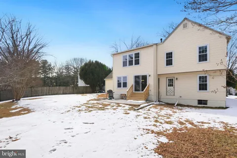 a view of a house with snow on the road