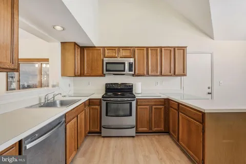 a kitchen with a sink stove and cabinets