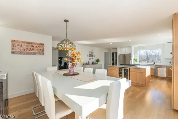 a dining room with furniture wooden floor and a chandelier