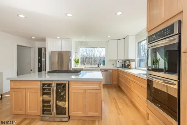 a kitchen with stainless steel appliances granite countertop a stove and a sink