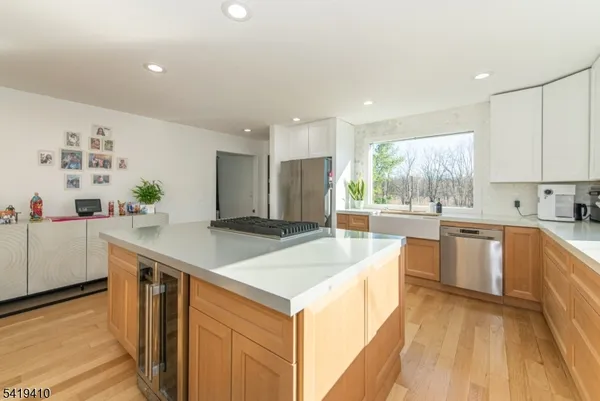 a kitchen with stainless steel appliances granite countertop a sink and a stove