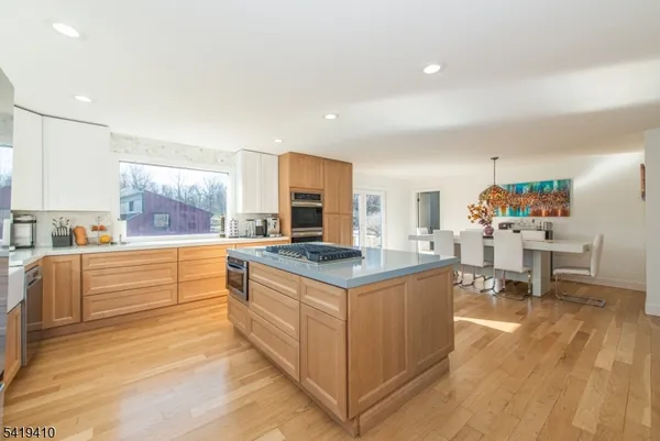 a kitchen with stainless steel appliances kitchen island granite countertop a stove and a sink