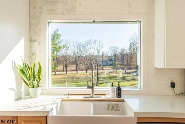 a kitchen with a sink and a large window