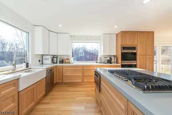 a large kitchen with stainless steel appliances granite countertop a stove and a sink