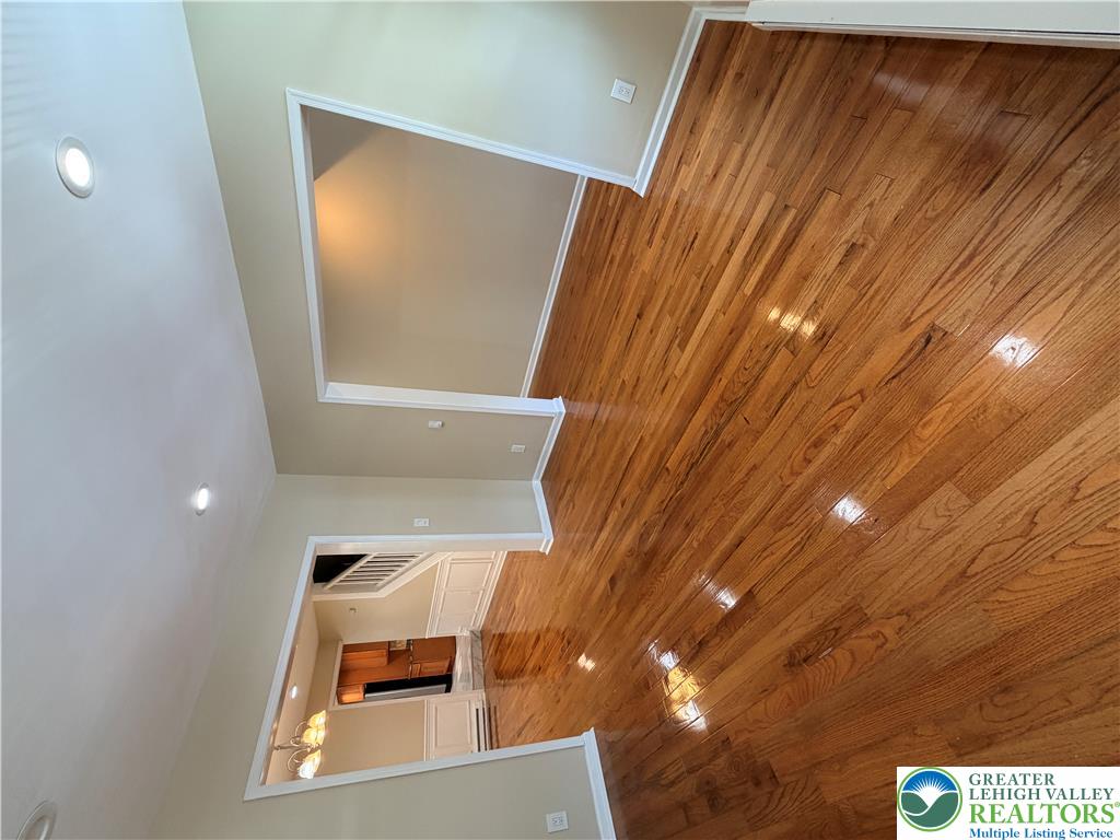 718 Ferry Street Easton, PA 18042 - Photo 3 of 37 Lustrous hardwood floors extend throughout the main living areas, complemented by subtle recessed lighting.