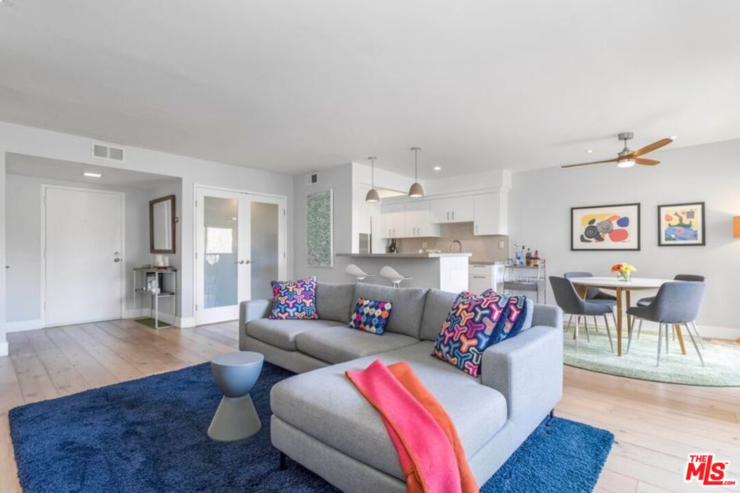 1221 North Kings Road, Unit 208 West Hollywood, CA 90069 - Photo 1 of 25 a living room with furniture and wooden floor