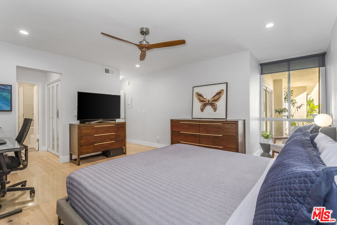 1221 North Kings Road, Unit 208 West Hollywood, CA 90069 - Photo 11 of 25 a bedroom with a bed and a flat screen tv