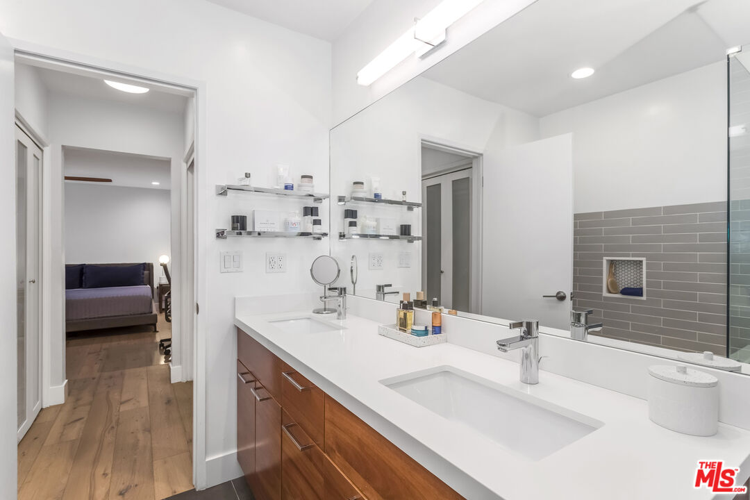1221 North Kings Road, Unit 208 West Hollywood, CA 90069 - Photo 15 of 25 a en suite bathroom with a double vanity sink a mirror and shower